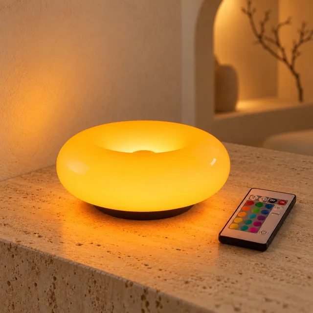 Orange Halo lamp glowing on a bedside table at night